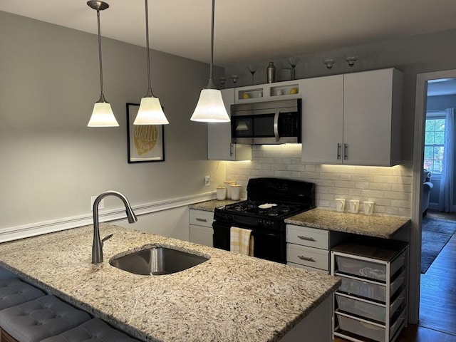 80 Brush Hill Ave Unit 19, West Springfield, MA 01089 - kitchen with stainless steel microwave, black gas range oven, light stone counters, and decorative backsplash