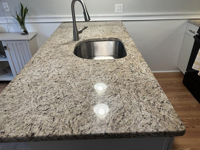 80 Brush Hill Ave Unit 19, West Springfield, MA 01089 - kitchen view of light stone countertops, dark wood-style flooring, and white cabinets