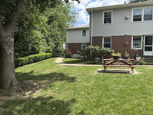 80 Brush Hill Ave Unit 19, West Springfield, MA 01089 - rear view of property with brick siding and a yard