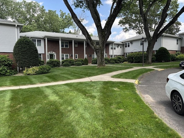 80 Brush Hill Ave Unit 19, West Springfield, MA 01089 - view of front facade with brick siding and a front yard