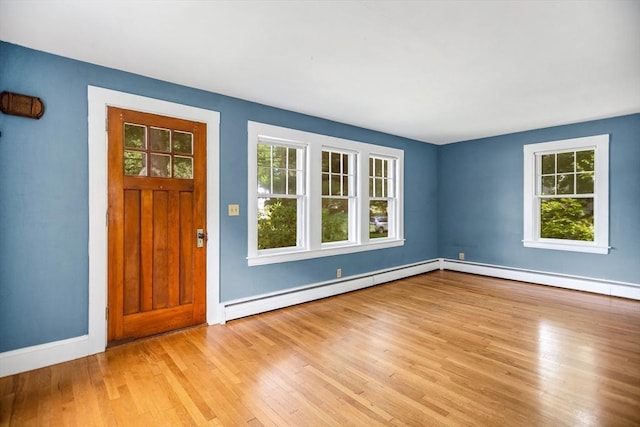 1178 Washington St, Walpole, MA 02081 - foyer with healthy amount of natural light, light wood finished floors, a baseboard heating unit, and baseboards