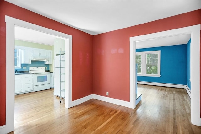 1178 Washington St, Walpole, MA 02081 - unfurnished room with light wood-style flooring, baseboards, and a baseboard radiator
