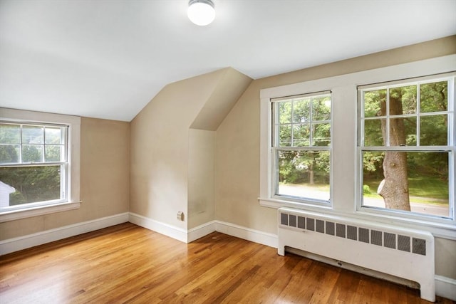 1178 Washington St, Walpole, MA 02081 - bonus room featuring radiator heating unit, light wood-style floors, baseboards, and vaulted ceiling