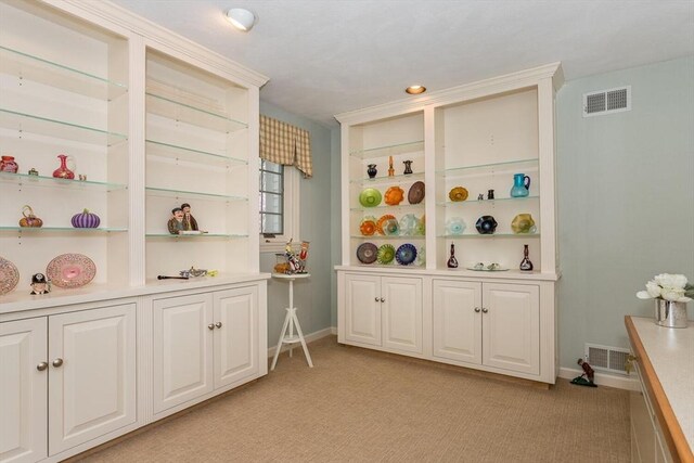 rec room with baseboards, light carpet, and visible vents