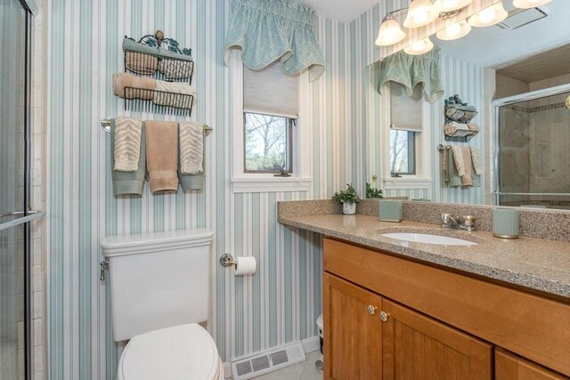 bathroom featuring visible vents, a stall shower, vanity, toilet, and wallpapered walls