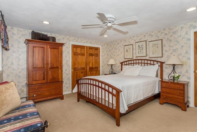 bedroom featuring recessed lighting, wallpapered walls, and light colored carpet
