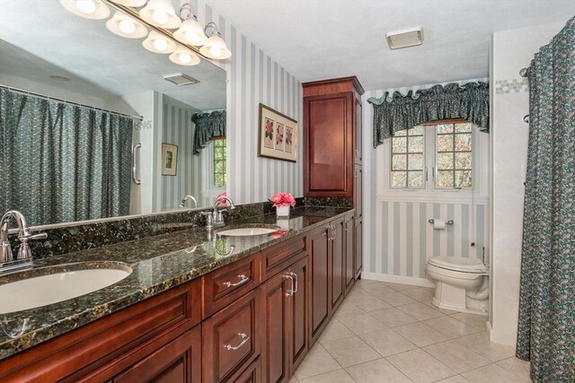 full bathroom featuring tile patterned flooring, a sink, toilet, and wallpapered walls