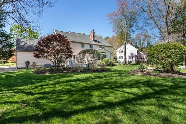 exterior space featuring a yard and a chimney