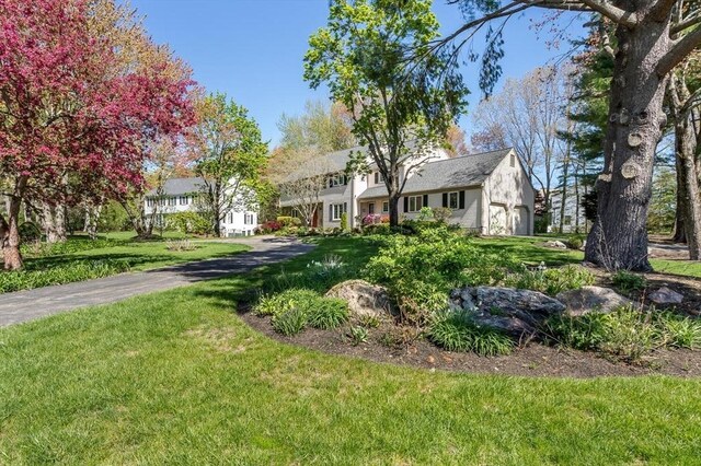 view of front of house featuring a chimney and a front yard