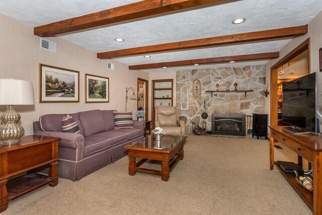 carpeted living room featuring a textured ceiling, a stone fireplace, recessed lighting, beamed ceiling, and visible vents