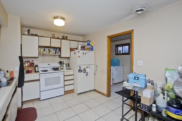 kitchen featuring white cabinetry, white appliances, independent washer and dryer, and light tile patterned flooring