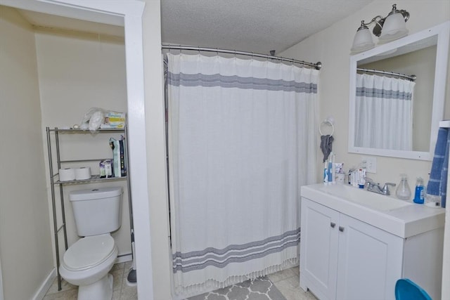 bathroom with curtained shower, vanity, toilet, tile patterned floors, and a textured ceiling