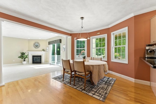 22 Campbell Rd, Middleton, MA 01949 - dining room with light wood-style flooring, decorative columns, healthy amount of natural light, a fireplace with flush hearth, and crown molding