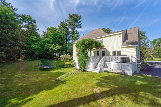 22 Campbell Rd, Middleton, MA 01949 - back of house featuring a trampoline, a wooden deck, a yard, and stairs