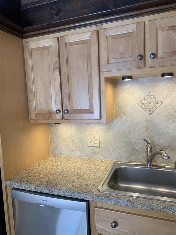 kitchen featuring tasteful backsplash, dishwasher, light countertops, light brown cabinetry, and a sink