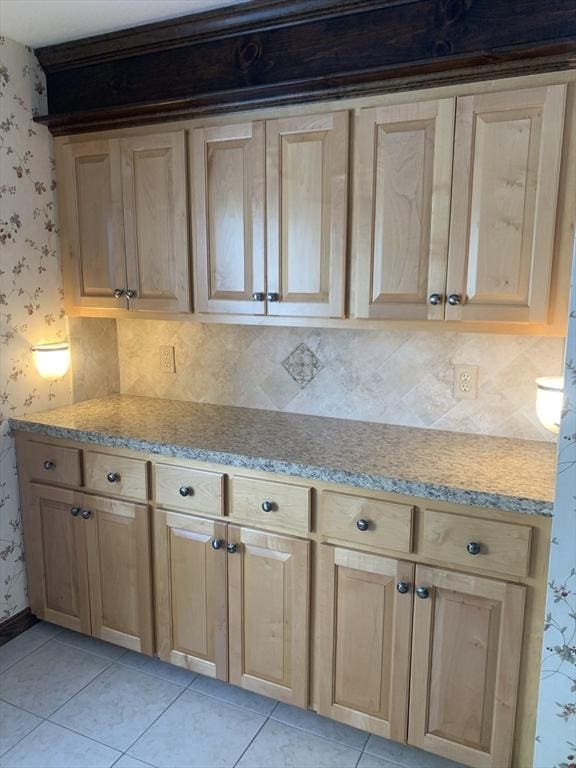 kitchen with light tile patterned floors, light countertops, and wallpapered walls