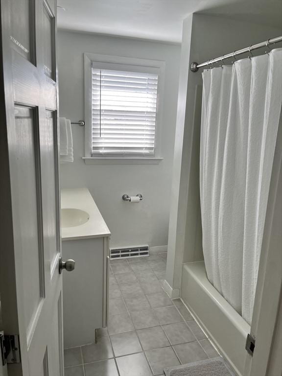 bathroom featuring vanity, baseboards, visible vents, tile patterned floors, and shower / bath combo