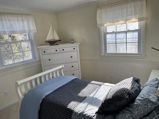 carpeted bedroom with baseboards and crown molding