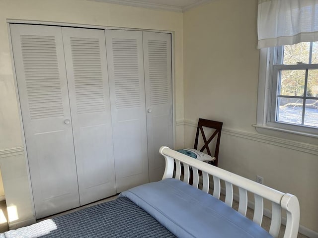 bedroom featuring a closet and crown molding