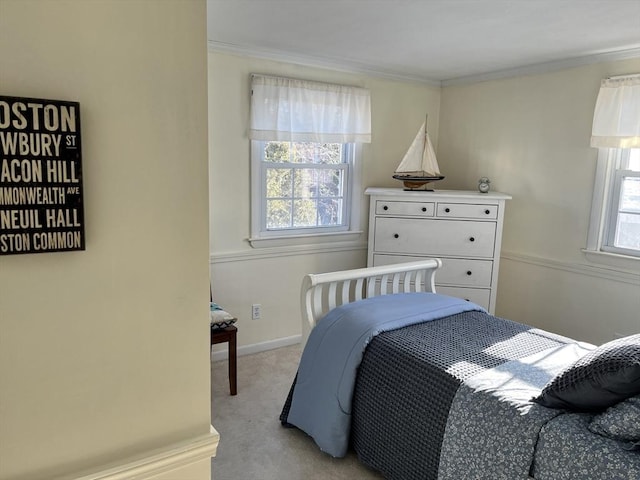 bedroom with ornamental molding, multiple windows, and light carpet