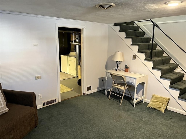 carpeted home office featuring a textured ceiling, visible vents, and washer and dryer