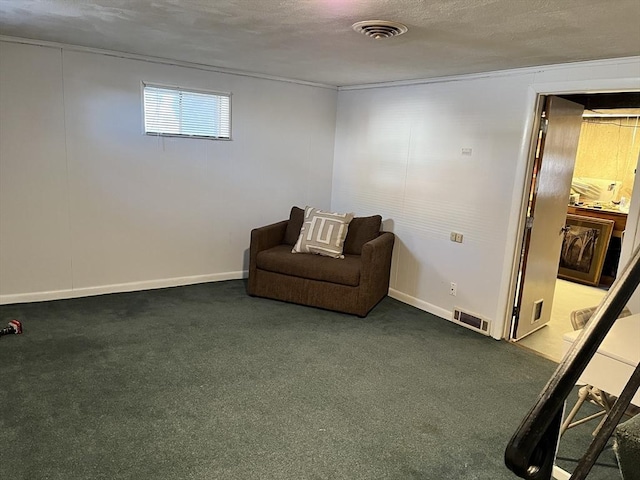 living area featuring baseboards, carpet, visible vents, and a textured ceiling