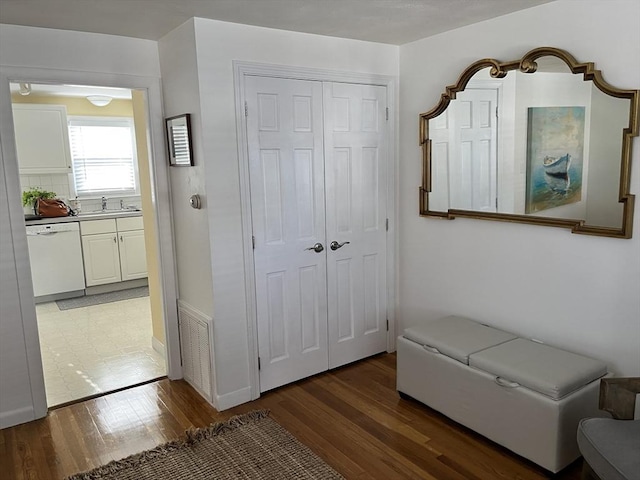 interior space featuring a closet, light wood-type flooring, a sink, and visible vents