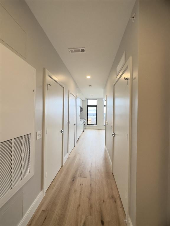 corridor with light wood-type flooring