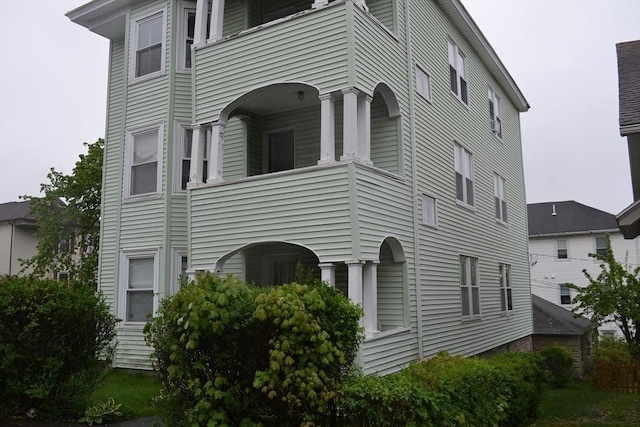 view of side of home with a balcony