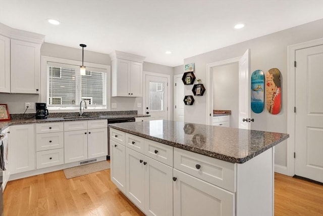 111 Union St Unit 8, Westfield, MA 01085 - kitchen featuring plenty of natural light, white cabinets, light wood-type flooring, a center island, and recessed lighting