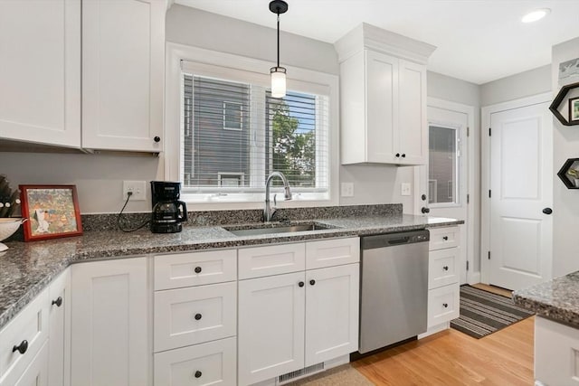 111 Union St Unit 8, Westfield, MA 01085 - kitchen featuring dishwasher, light wood finished floors, white cabinets, pendant lighting, and dark stone counters