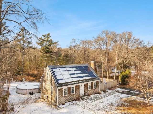 snow covered structure with solar panels