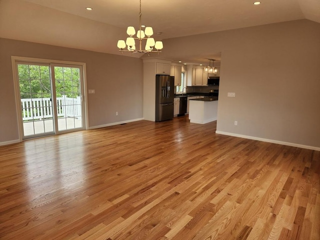 56 Kelly Ln, Lynn, MA 01904 - unfurnished living room with a chandelier, lofted ceiling, light wood-style floors, baseboards, and recessed lighting