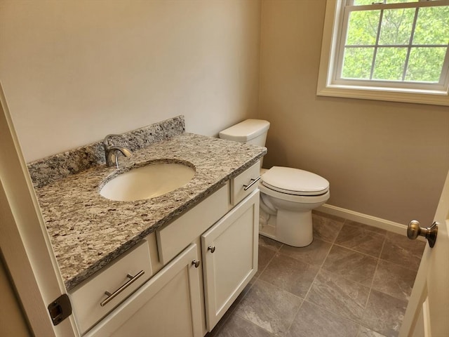 56 Kelly Ln, Lynn, MA 01904 - half bathroom featuring vanity, toilet, baseboards, and tile patterned floors
