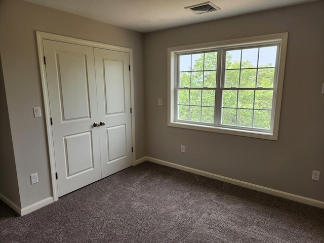 56 Kelly Ln, Lynn, MA 01904 - unfurnished bedroom featuring dark colored carpet, baseboards, and a closet