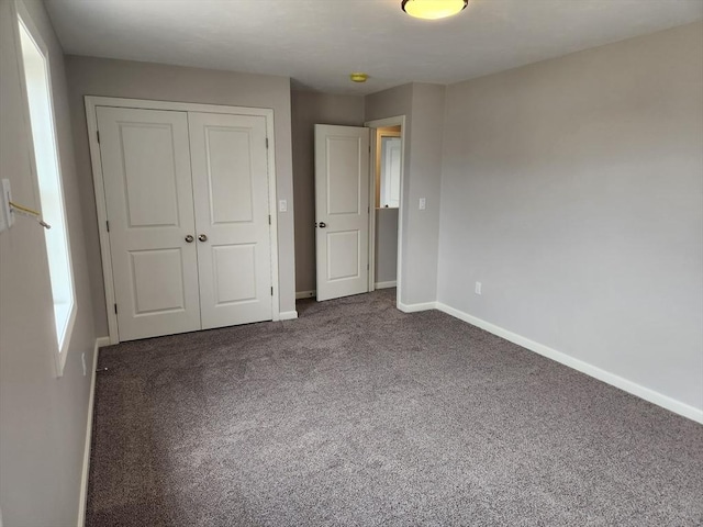 56 Kelly Ln, Lynn, MA 01904 - unfurnished bedroom featuring baseboards, carpet flooring, and a closet
