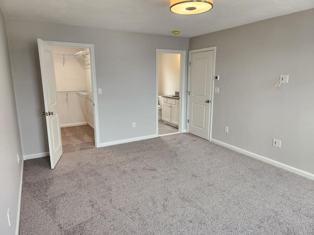 56 Kelly Ln, Lynn, MA 01904 - unfurnished bedroom featuring a spacious closet, carpet flooring, a closet, baseboards, and ensuite bath