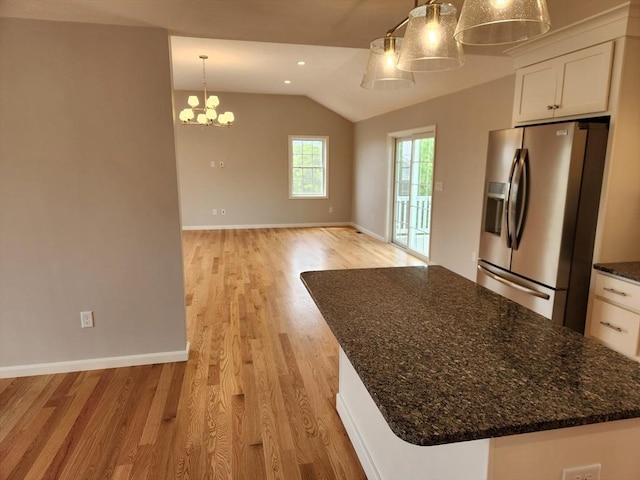 56 Kelly Ln, Lynn, MA 01904 - kitchen with stainless steel refrigerator with ice dispenser, vaulted ceiling, light wood finished floors, white cabinetry, and baseboards