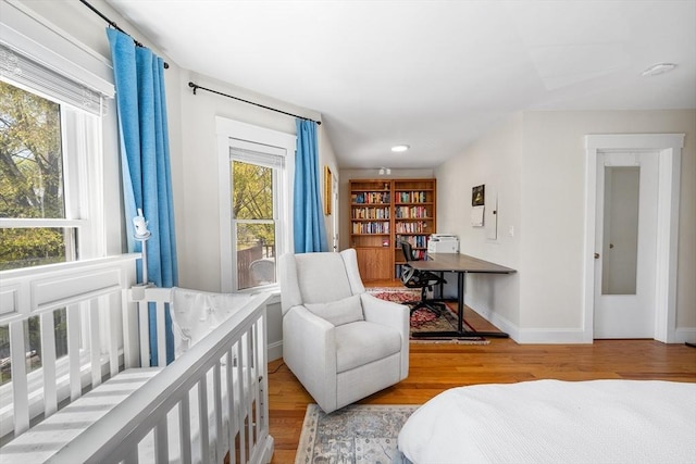 bedroom with baseboards, recessed lighting, and wood finished floors