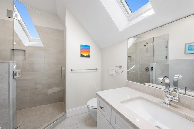 bathroom with tile patterned flooring, vanity, toilet, lofted ceiling with skylight, and a shower stall