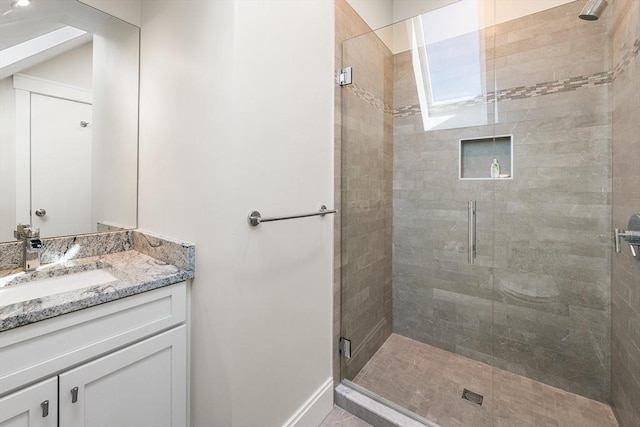 bathroom with vanity and a shower stall