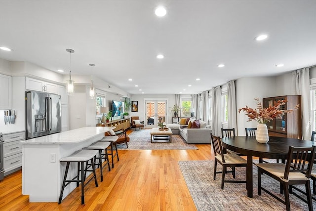 dining space with light wood-type flooring and recessed lighting