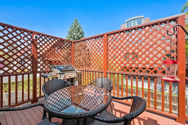 wooden deck featuring outdoor dining area and grilling area
