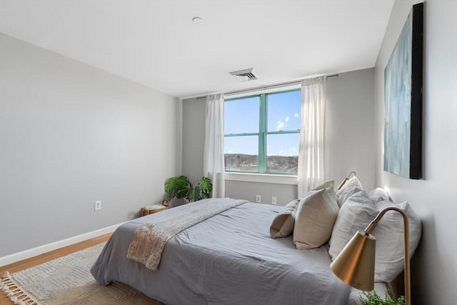 bedroom with hardwood / wood-style flooring