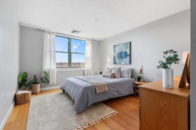 bedroom with hardwood / wood-style flooring