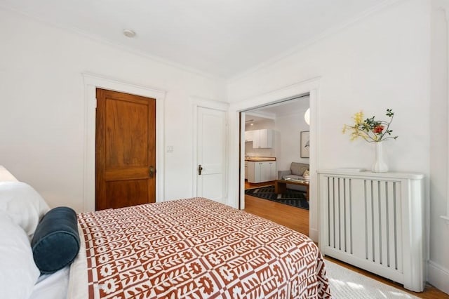 7 Linnaean St Unit 1, Cambridge, MA 02138 - bedroom featuring wood finished floors, crown molding, and connected bathroom