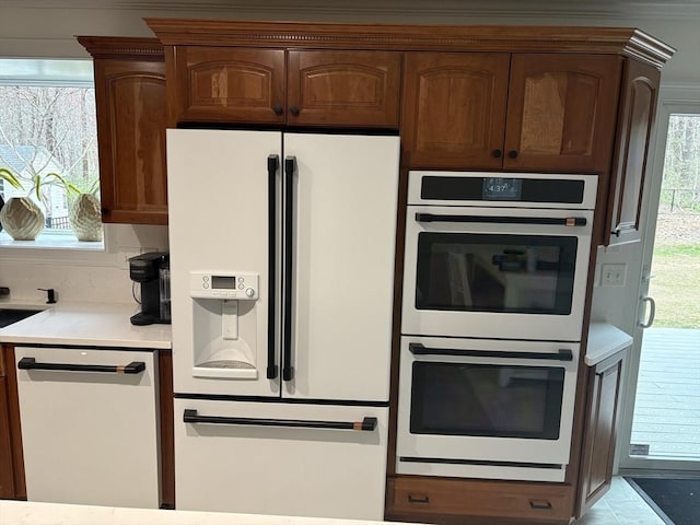 kitchen featuring light countertops and white appliances
