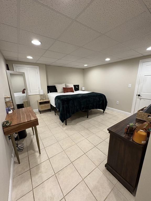 bedroom featuring light tile patterned flooring and recessed lighting