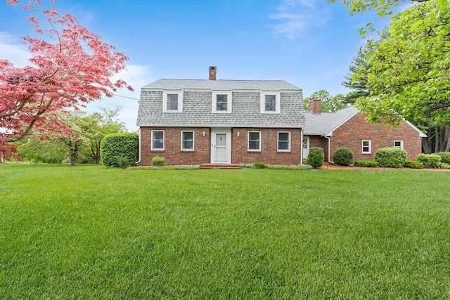 20 Highwood Way, North Andover, MA 01845 - colonial inspired home featuring a chimney, a gambrel roof, roof with shingles, brick siding, and a front yard