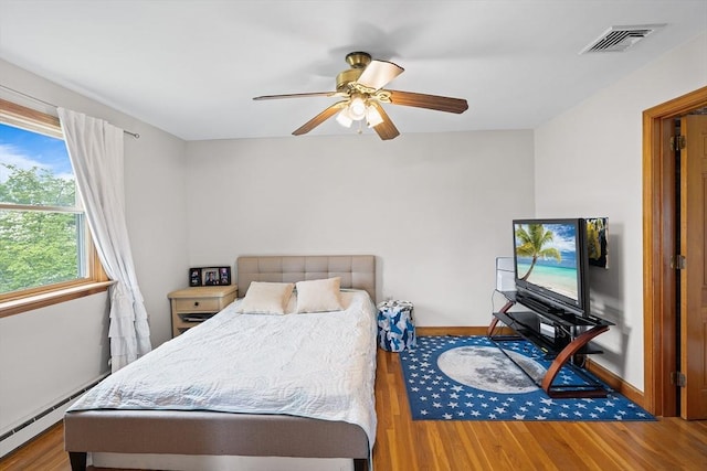 20 Highwood Way, North Andover, MA 01845 - bedroom featuring a baseboard heating unit, wood finished floors, baseboards, and a ceiling fan